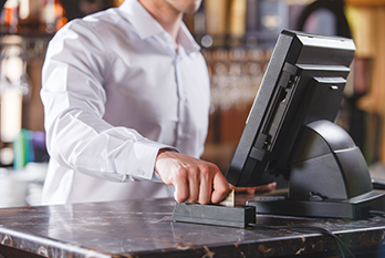 Restaurant employee using credit card to make payment